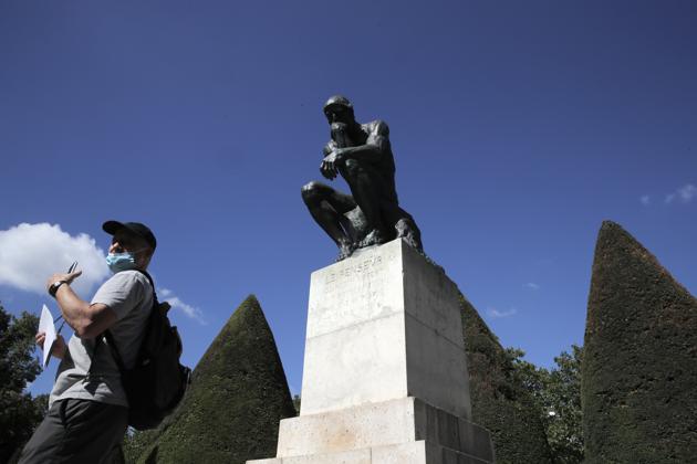 A visitor walks past "Le Penseur" (The Thinker) by French sculptor Auguste Rodin in Paris Tuesday, July 7, 2020. (AP) A visitor walks past "Le Penseur" (The Thinker) by French sculptor Auguste Rodin in Paris Tuesday, July 7, 2020. (AP)