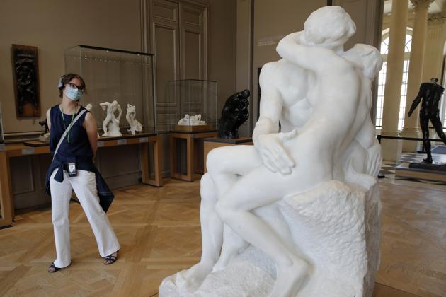 A visitor watches Le Baiser (The Kiss) by French sculptor Auguste Rodin in Paris Tuesday, July 7, 2020 (AP) A visitor watches Le Baiser (The Kiss) by French sculptor Auguste Rodin in Paris Tuesday, July 7, 2020 (AP)