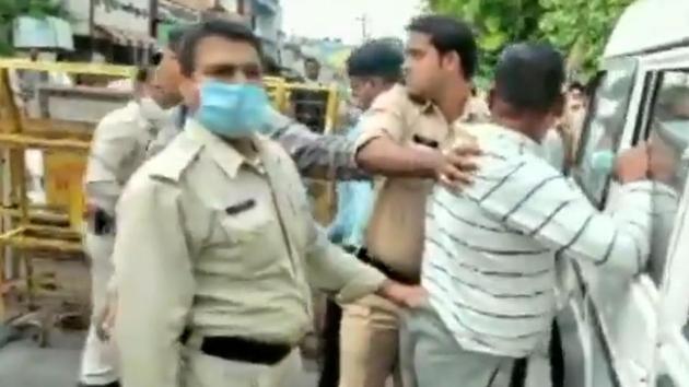 Gangster Vikas Dubey held by the police in Ujjain after his arrest on Thursday. (ANI Photo) Gangster Vikas Dubey held by the police in Ujjain after his arrest on Thursday. (ANI Photo)