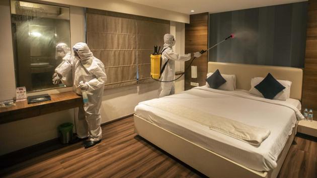 Staff in a hotel sanitize a room at in Pune on July 7. Under new orders by the Maharashtra government, hotels and entities providing accommodation services like lodges and guest houses outside containment zones began operating from July 8 at 33% capacity. The remainder will still be available for the government to use for quarantine and other purposes as mandated earlier. (Pratham Gokhale / HT Photo)