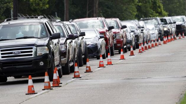 People wait inside their vehicles in line at Covid-19 testing site on Wednesday. (AP File Photo) People wait inside their vehicles in line at Covid-19 testing site on Wednesday. (AP File Photo)