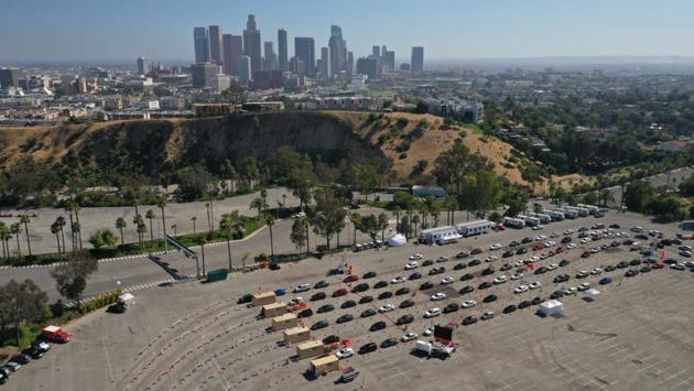 An aerial view of cars lined up at a Covid-19 drive-thru testing site at the parking lot of Dodger Stadium in Los Angeles on July 7. According to a report by HT, on July 8 the number of confirmed infections went up by a record single-day spike of 60,021 to 3,009,611 and the fatalities climbed by 1,195 to 131,594. (Bing Guan / Bloomberg)