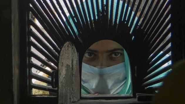 A local visitor waits for tickets outside Mughal Garden on the outskirts of Srinagar, Kashmir, Wednesday, July 8, 2020. (AP)