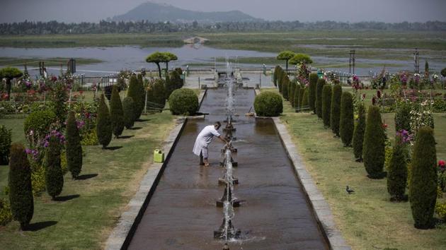 A government employee checks a water fountain inside Mughal Garden on the outskirts of Srinagar, Kashmir, Wednesday, July 8, 2020. (AP)