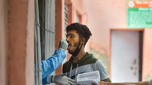 A health worker takes swab samples for COVID-19 testing, during Unlock 2.0, in Ghaziabad. (PTI) A health worker takes swab samples for COVID-19 testing, during Unlock 2.0, in Ghaziabad. (PTI)