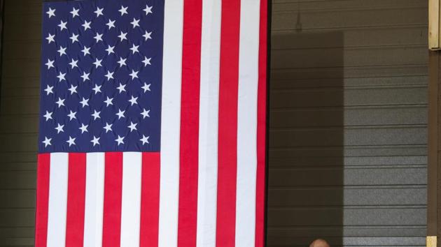 A US Secret Service agent stands at his post beside a large American flag in Dunmore, Pennsylvania.(REUTERS) A US Secret Service agent stands at his post beside a large American flag in Dunmore, Pennsylvania.(REUTERS)