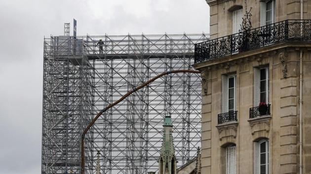 French President Emmanuel Macron, who wants Notre Dame reopened in time for the 2024 Olympics, had initially pushed for a contemporary touch atop the cathedral, prompting eye-catching proposals from architects around the world.(AP Photo)