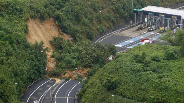 A landslide is seen near an exit of a highway in Kyoto on July 9. Japan’s Fire and Disaster Management Agency told AFP that rising floodwater or roads damaged by landslides had blocked access to more than 3,000 households, mostly in the hardest-hit southwestern region of Kumamoto where fresh downpours were forecast. (Kyodo News / AP)