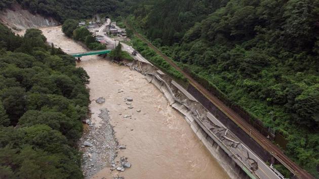 An aerial image shows a collapsed road alongside River Hida after it was damaged in heavy rains in Gero village, on July 9. Japan Meteorological Agency (JMA) issued an advisory that “heavy rain will likely continue at least until July 12 in a wide area” of the country, calling for “extreme vigilance” on landslide risks and flooding in low-lying areas. The death toll has climbed gradually as more victims are discovered in isolated areas, reported AFP. (Quentin TYBERGHIEN / AFP)