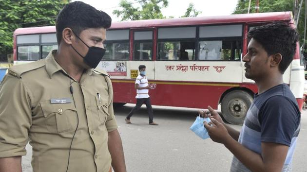 A police personnel checks a man for not wearing a face mask in public, at Qaiserbagh Bus Station, Lucknow, on July 9. (Dheeraj Dhawan / HT) A police personnel checks a man for not wearing a face mask in public, at Qaiserbagh Bus Station, Lucknow, on July 9. (Dheeraj Dhawan / HT)