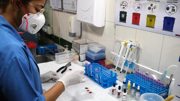 A technician wearing a face mask analyses a blood sample in a serology lab at the Delhi Plasma Bank for Covid-19 patients who will receive the trial antibody treatment at the Institute of Liver and Biliary Sciences (ILBS) hospital in New Delhi. (BLOOMBERG PHOTO.) A technician wearing a face mask analyses a blood sample in a serology lab at the Delhi Plasma Bank for Covid-19 patients who will receive the trial antibody treatment at the Institute of Liver and Biliary Sciences (ILBS) hospital in New Delhi. (BLOOMBERG PHOTO.)