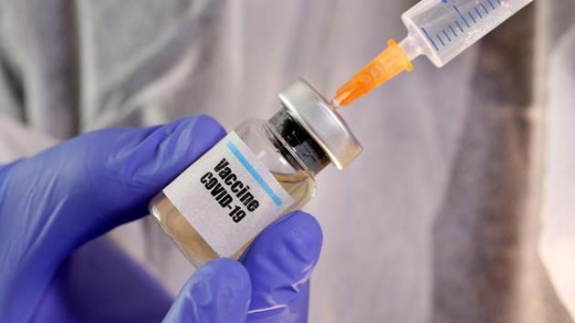 A woman holds a small bottle labelled with a "Vaccine Covid-19" sticker and a medical syringe in this illustration. (Reuters File Photo) A woman holds a small bottle labelled with a "Vaccine Covid-19" sticker and a medical syringe in this illustration. (Reuters File Photo)