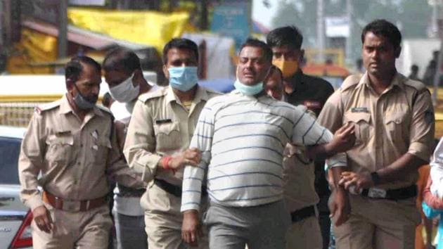 Ujjain: Notorious gangster Vikas Dubey, the main accused in killing of eight policemen in the Kanpur encounter recently, being apprehended by police personnel after a nearly week-long manhunt, in Ujjain. (PTI) Ujjain: Notorious gangster Vikas Dubey, the main accused in killing of eight policemen in the Kanpur encounter recently, being apprehended by police personnel after a nearly week-long manhunt, in Ujjain. (PTI)
