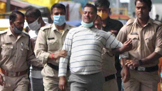 Gangster Vikas Dubey, the main accused in killing of eight policemen in the Kanpur encounter recently, being apprehended by police personnel after a nearly week-long manhunt, in Ujjain on Thursday.(PTI Photo)