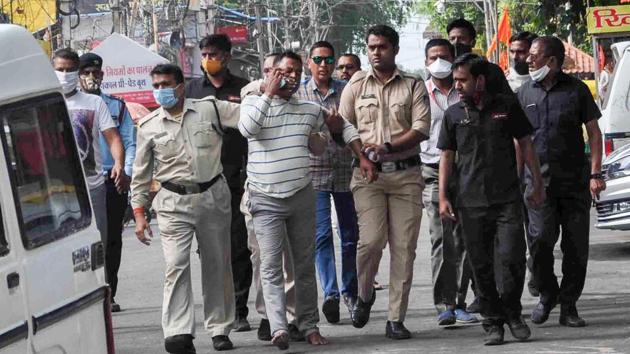 Gangster Vikas Dubey was apprehended by police personnel after a nearly week-long manhunt, in Ujjain on Thursday. (PTI Photo) Gangster Vikas Dubey was apprehended by police personnel after a nearly week-long manhunt, in Ujjain on Thursday. (PTI Photo)