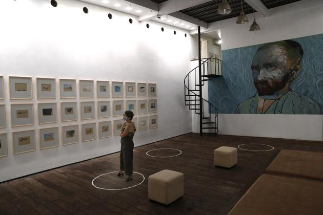 A visitor looks at art pieces by Indonesian artist Hanafi as she stands on a physical distancing marker placed on the floor as a precaution against the new coronavirus during an exhibition at Kertas Gallery in di Depok, West Java, Indonesia, Thursday, July 9, 2020. (AP) A visitor looks at art pieces by Indonesian artist Hanafi as she stands on a physical distancing marker placed on the floor as a precaution against the new coronavirus during an exhibition at Kertas Gallery in di Depok, West Java, Indonesia, Thursday, July 9, 2020. (AP)