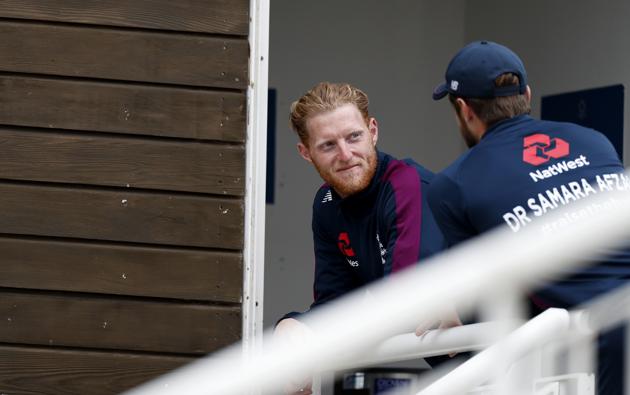 England's captain Ben Stokes, left, spends time with a teammate as rain delayed start of the first day of the 1st cricket Test match between England and West Indies, at the Ageas Bowl in Southampton, England, Wednesday July 8, 2020. (Adrian Dennis/Pool via AP) (AP)