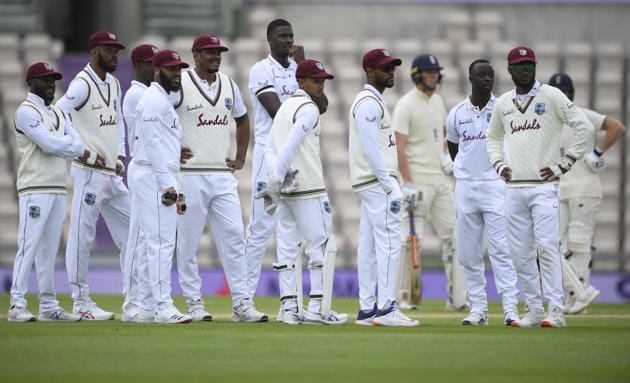 West Indies' captain Jason Holder, center without cap, and teammates wait for the third umpire's decision for the wicket of England's Zak Crawley during the second day of the first cricket Test match between England and West Indies, at the Ageas Bowl in Southampton, England, Thursday, July 9, 2020. (Mike Hewitt/Pool via AP) (AP) West Indies' captain Jason Holder, center without cap, and teammates wait for the third umpire's decision for the wicket of England's Zak Crawley during the second day of the first cricket Test match between England and West Indies, at the Ageas Bowl in Southampton, England, Thursday, July 9, 2020. (Mike Hewitt/Pool via AP) (AP)