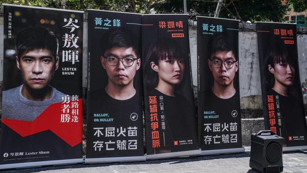 Election campaign banners of candidates Lester Shum (L), Joshua Wong, (C) and Janelle Leung are displayed during the primary polls in Hong Kong on July 11. Voting in the two-day primary will continue until July 12. (Lam Yik / Bloomberg) Election campaign banners of candidates Lester Shum (L), Joshua Wong, (C) and Janelle Leung are displayed during the primary polls in Hong Kong on July 11. Voting in the two-day primary will continue until July 12. (Lam Yik / Bloomberg)