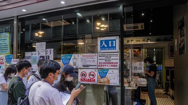 People line up outside a temporary polling station in a restaurant during an unofficial primary election, organized by pro-democracy opposition parties to select favored candidates for the upcoming legislative election, in Hong Kong on July 11, 2020. (Bloomberg Photo) People line up outside a temporary polling station in a restaurant during an unofficial primary election, organized by pro-democracy opposition parties to select favored candidates for the upcoming legislative election, in Hong Kong on July 11, 2020. (Bloomberg Photo)