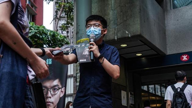 Joshua Wong, activist and founding member of pro democracy party Demosisto, hands a pamphlet as he speaks outside MTR Corporation’s Lam Tin station during the primary polls in Hong Kong on July 11. According to an AFP report, more than 137,000 people had cast their votes until 6pm on July 11. (Lam Yik / Bloomberg) Joshua Wong, activist and founding member of pro democracy party Demosisto, hands a pamphlet as he speaks outside MTR Corporation’s Lam Tin station during the primary polls in Hong Kong on July 11. According to an AFP report, more than 137,000 people had cast their votes until 6pm on July 11. (Lam Yik / Bloomberg)