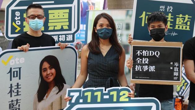Gwyneth Ho (C), a candidate of New Territory East, together with social activists Lester Shum (R) and Anthony Wong (L) campaign during primary polls in Hong Kong on July 11. Pro democracy parties in Hong Kong held primary polls on July 11 to choose candidates for upcoming legislative elections despite warnings from government officials that it may be in breach of the new security law imposed by China. (May James / AFP) Gwyneth Ho (C), a candidate of New Territory East, together with social activists Lester Shum (R) and Anthony Wong (L) campaign during primary polls in Hong Kong on July 11. Pro democracy parties in Hong Kong held primary polls on July 11 to choose candidates for upcoming legislative elections despite warnings from government officials that it may be in breach of the new security law imposed by China. (May James / AFP)
