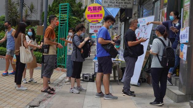 People queue up to vote during the primary polls in Hong Kong. Thousands queued at unofficial polling stations across the city on June 11, hours after police raided an opinion pollster helping to conduct the vote. (Vincent Yu / AP) People queue up to vote during the primary polls in Hong Kong. Thousands queued at unofficial polling stations across the city on June 11, hours after police raided an opinion pollster helping to conduct the vote. (Vincent Yu / AP)