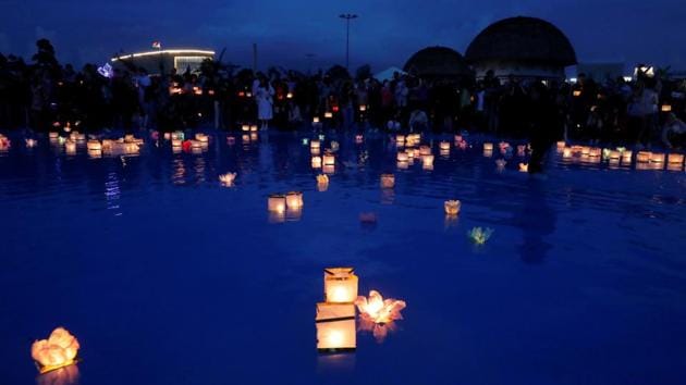 People take part in festival of water lanterns at the amusement park 'Dreamland' in Minsk, July 10, 2020. (REUTERS) People take part in festival of water lanterns at the amusement park 'Dreamland' in Minsk, July 10, 2020. (REUTERS)