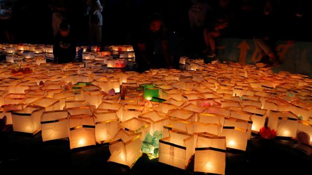 People take part in festival of water lanterns at the amusement park 'Dreamland' in Minsk, July 10, 2020. (REUTERS) People take part in festival of water lanterns at the amusement park 'Dreamland' in Minsk, July 10, 2020. (REUTERS)
