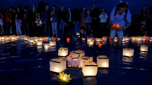 People take part in festival of water lanterns at the amusement park "Dreamland' in Minsk, July 10, 2020. (REUTERS) People take part in festival of water lanterns at the amusement park "Dreamland' in Minsk, July 10, 2020. (REUTERS)