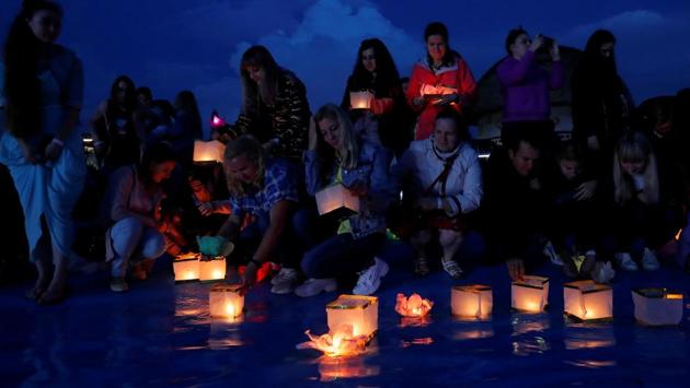 People take part in festival of water lanterns at the amusement park 'Dreamland' in Minsk, July 10, 2020. (REUTERS) People take part in festival of water lanterns at the amusement park 'Dreamland' in Minsk, July 10, 2020. (REUTERS)