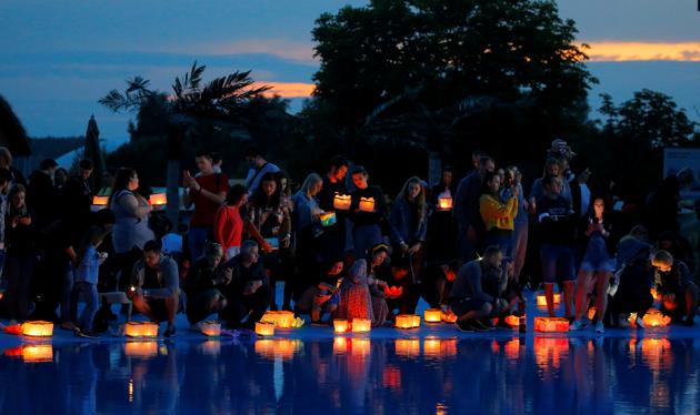 People take part in festival of water lanterns at the amusement park 'Dreamland' in Minsk, July 10, 2020. (REUTERS) People take part in festival of water lanterns at the amusement park 'Dreamland' in Minsk, July 10, 2020. (REUTERS)