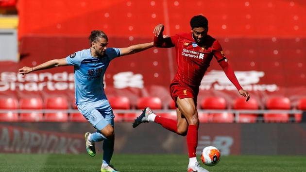 Liverpool's Joe Gomez in action with Burnley's Jay Rodriguez, as play resumes behind closed doors following the outbreak of the coronavirus disease (COVID-19) Pool via REUTERS/Phil Noble(Pool via REUTERS) Liverpool's Joe Gomez in action with Burnley's Jay Rodriguez, as play resumes behind closed doors following the outbreak of the coronavirus disease (COVID-19) Pool via REUTERS/Phil Noble(Pool via REUTERS)