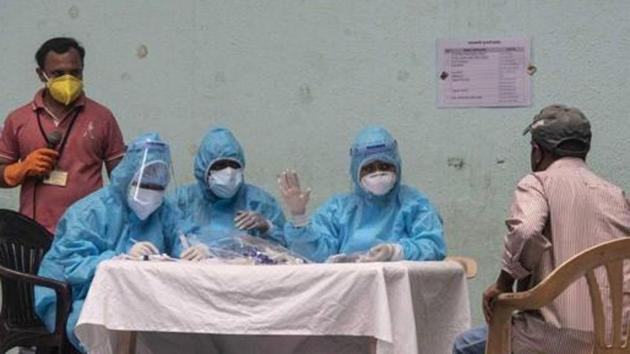 Healthcare workers register names of people for Covid-19 testing, at Sane Guruji Smarak. (Pratham Gokhale/HT Photo)