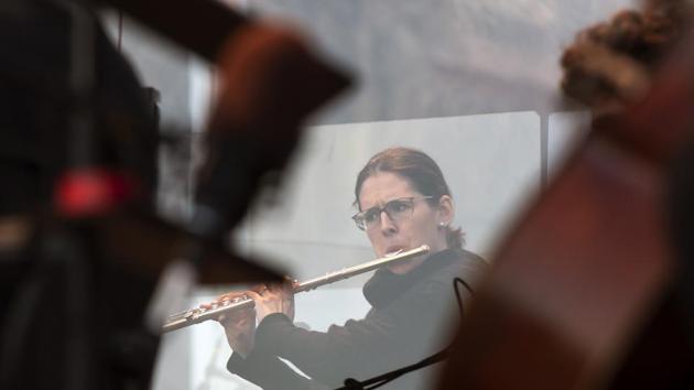 Orchestra musicians play behind plexiglass panes during the rehearsal of the Cathedral Steps open air festival (Domstufen-Festspiele) in front of the Mariendom (Cathedral of Mary) and the St. Severi's Church in Erfurt, Germany, Wednesday, July 8, 2020. (AP) Orchestra musicians play behind plexiglass panes during the rehearsal of the Cathedral Steps open air festival (Domstufen-Festspiele) in front of the Mariendom (Cathedral of Mary) and the St. Severi's Church in Erfurt, Germany, Wednesday, July 8, 2020. (AP)