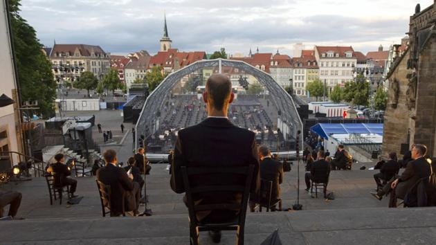 Singers sit apart prior the rehearsal of the Cathedral Steps open air festival (Domstufen-Festspiele) in front of Mariendom (Cathedral of Mary) and St. Severi's Church in Erfurt, Germany, Wednesday, July 8, 2020. (AP) Singers sit apart prior the rehearsal of the Cathedral Steps open air festival (Domstufen-Festspiele) in front of Mariendom (Cathedral of Mary) and St. Severi's Church in Erfurt, Germany, Wednesday, July 8, 2020. (AP)