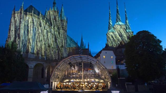 Singers and orchestra musicians perform during a rehearsal of the Cathedral Steps open air festival (Domstufen-Festspiele) in front of Mariendom (Cathedral of Mary) and St. Severi's Church in Erfurt, Germany, Wednesday, July 8, 2020. (AP) Singers and orchestra musicians perform during a rehearsal of the Cathedral Steps open air festival (Domstufen-Festspiele) in front of Mariendom (Cathedral of Mary) and St. Severi's Church in Erfurt, Germany, Wednesday, July 8, 2020. (AP)