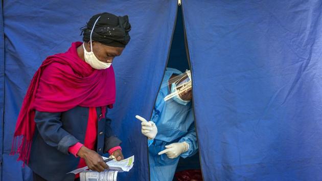 Heath officials check the listings of people who are to be tested for Covid-19 as well as HIV and Tuberculosis, in downtown Johannesburg . (AP file photo) Heath officials check the listings of people who are to be tested for Covid-19 as well as HIV and Tuberculosis, in downtown Johannesburg . (AP file photo)
