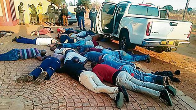 A photo released by police shows suspects lying on the ground at the site of the hostage incident in Johannesburg. A photo released by police shows suspects lying on the ground at the site of the hostage incident in Johannesburg.