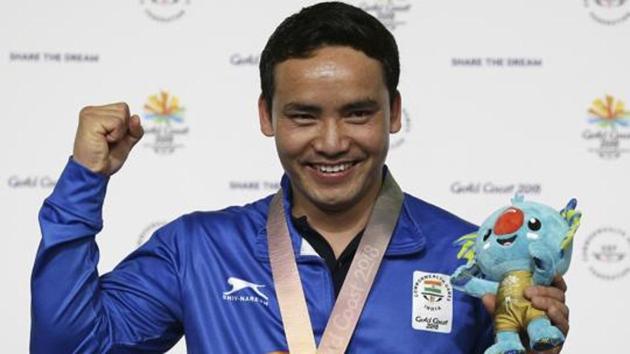 Jitu Rai of India poses with his gold medal in the men's 10m Air Pistol final at the Belmont Shooting Centre during the 2018 Commonwealth Games in Brisbane.(AP)