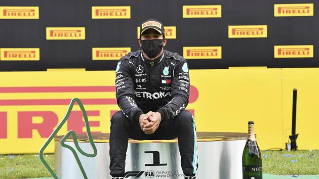 Mercedes driver Lewis Hamilton of Britain sits on the podium after winning the Styrian Formula One Grand Prix at the Red Bull Ring racetrack in Spielberg, Austria, Sunday, July 12, 2020.(AP)