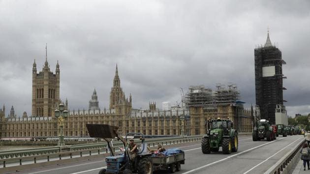 Farmers from the group Save British Farming drive tractors across Westminster Bridge, backdropped by the Houses of Parliament and the scaffolded Big Ben tower in London. (AP) Farmers from the group Save British Farming drive tractors across Westminster Bridge, backdropped by the Houses of Parliament and the scaffolded Big Ben tower in London. (AP)