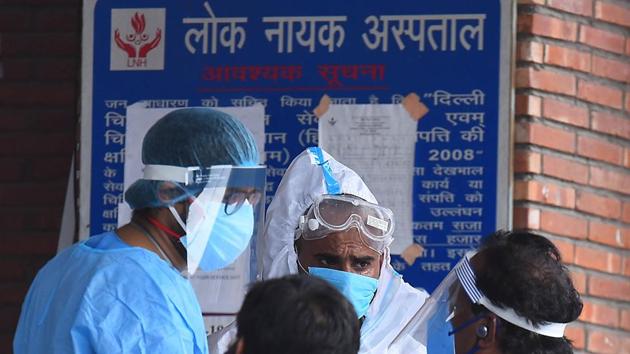 Medical workers speak with family members of a people admitted with coronavirus infections, outside the Covid-19 ward, at Lok Nayak Jai Prakash Narayan Hospital, in New Delhi. (Raj K Raj/HT PHOTO) Medical workers speak with family members of a people admitted with coronavirus infections, outside the Covid-19 ward, at Lok Nayak Jai Prakash Narayan Hospital, in New Delhi. (Raj K Raj/HT PHOTO)