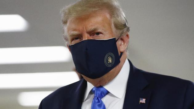President Donald Trump wears a face mask as he walks down a hallway during a visit to Walter Reed National Military Medical Center in Bethesda, Md., Saturday, July 11, 2020.(AP photo)