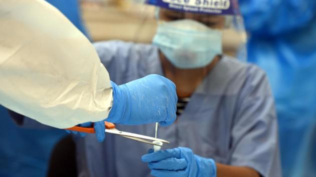 A health worker handles a swab sample collected for Covid-19 antigen testing in New Delhi on July 11. 19,235 Covid-19 patients were cured and discharged in the last 24 hours, the health ministry’s dashboard showed on July 12 morning. (Sonu Mehta / HT Photo) A health worker handles a swab sample collected for Covid-19 antigen testing in New Delhi on July 11. 19,235 Covid-19 patients were cured and discharged in the last 24 hours, the health ministry’s dashboard showed on July 12 morning. (Sonu Mehta / HT Photo)