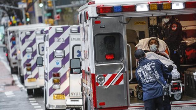 A patient arrives in an ambulance cared for by medical workers wearing personal protective equipment due to Covid-19 concerns outside NYU Langone Medical Center in New York. (AP) A patient arrives in an ambulance cared for by medical workers wearing personal protective equipment due to Covid-19 concerns outside NYU Langone Medical Center in New York. (AP)