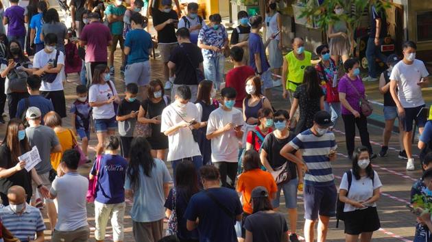 People queue up to vote in Hong Kong, Sunday, July 12, 2020, in an unofficial primary for pro-democracy candidates ahead of legislative elections in September.(AP) People queue up to vote in Hong Kong, Sunday, July 12, 2020, in an unofficial primary for pro-democracy candidates ahead of legislative elections in September.(AP)