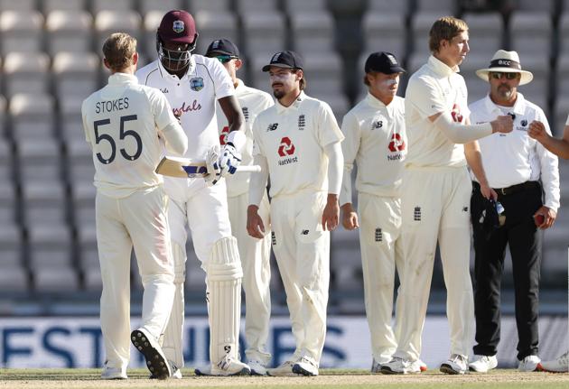 West Indies captain Jason Holder, second left, greets England captain Ben Stokes, left, after winning the first cricket Test match between England and West Indies, at the Ageas Bowl in Southampton, England, Sunday, July 12, 2020. (Adrian Dennis/Pool via AP) (AP)