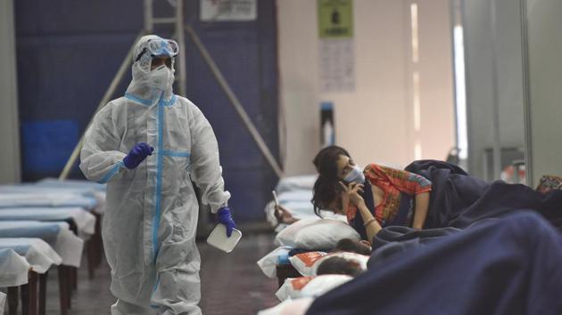 A health worker in PPE coveralls while serving food to Covid-19 patients housed at the Commonwealth Games Village Sports Complex which is a temporary coronavirus care centre, in New Delhi. (Biplov Bhuyan/HT PHOTO) A health worker in PPE coveralls while serving food to Covid-19 patients housed at the Commonwealth Games Village Sports Complex which is a temporary coronavirus care centre, in New Delhi. (Biplov Bhuyan/HT PHOTO)