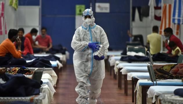 A health worker in PPE coveralls while serving food to Covid-19 patients housed at the Commonwealth Games Village Sports Complex which is a temporary coronavirus care centre at Patparganj in New Delhi on Sunday. (Biplov Bhuyan/HT Photo) A health worker in PPE coveralls while serving food to Covid-19 patients housed at the Commonwealth Games Village Sports Complex which is a temporary coronavirus care centre at Patparganj in New Delhi on Sunday. (Biplov Bhuyan/HT Photo)